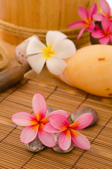 Obraz na płótnie Canvas tropical spa with frangipani flowers arrangement