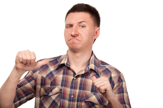 Man in a plaid shirt showing thumbs up to himself