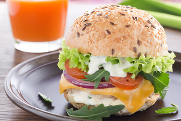 Burger with meat and vegetables.