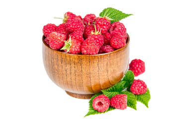 Ripe raspberries in wooden bowl