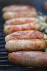 Sausages on grill with onions