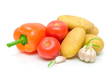 potatoes, peppers, tomatoes and garlic on a white background