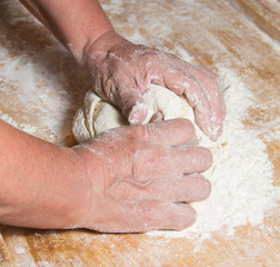 Fototapeta premium Hands kneading a dough