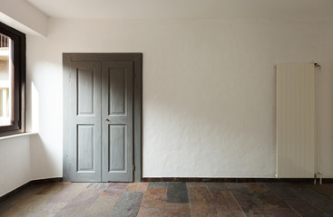 closed door in a rustic house, stone floor