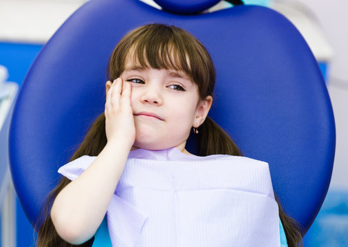 little girl at the dentist complains of toothache. 