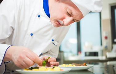 Chef garnishing a dish