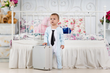 Fototapeta na wymiar Baby boy with a suitcase