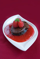 Chocolate Pancake with raspberries on a red background