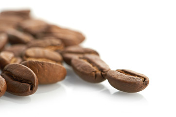 Macro of coffee beans isolated on white background
