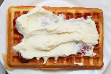 Belgian waffle with jam and whipped cream