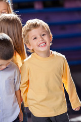 Boy Looking Away With Friends In Kindergarten