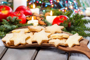 Homemade biscuits in star shape on wooden table in christmas eve