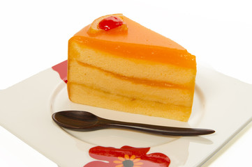 one piece of orange cake with wooden small spoon