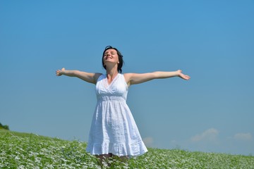 Young happy woman in green field