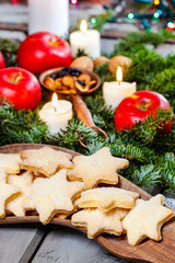 Homemade biscuits in star shape on wooden table in christmas eve