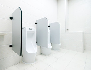 white porcelain urinals in public toilets