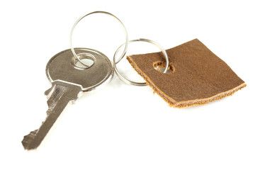 Key with leather trinket isolated on white