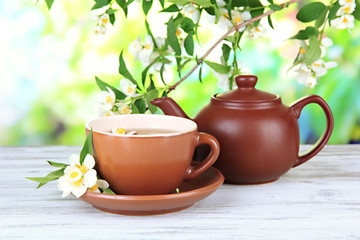 Cup of tea with jasmine, on bright background