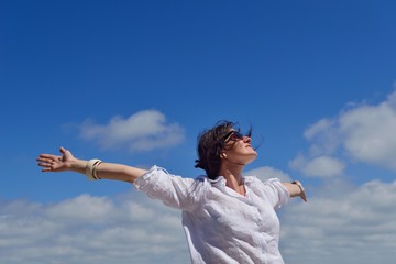 young woman with spreading arms to sky