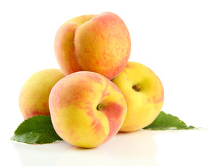 Ripe sweet peaches with leaves, isolated on white