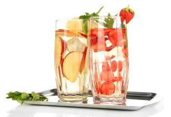 Glasses of fruit drinks with ice cubes isolated on white