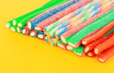 Obraz premium Sweet jelly candies on yellow background.