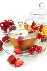 Cup of berry tea isolated on white