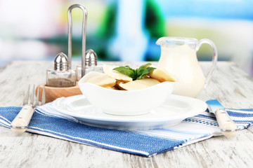 Fototapeta premium Tasty dumplings on white plate, on bright background