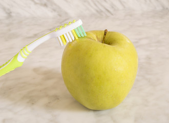 Apple and toothbrush
