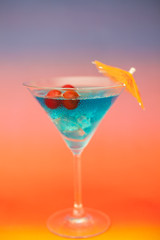 Blue cold cocktail with berries
