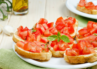 Italian bruschetta with tomato and basil on the plate