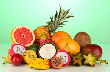 Composition of exotic fruits on green background