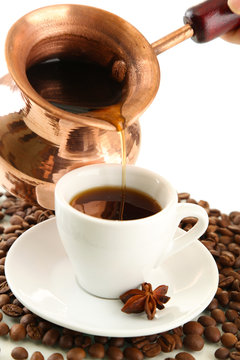Cup and pot of coffee and coffee beans, isolated on white