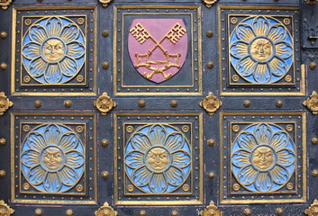 Wooden door with emblems in Prague