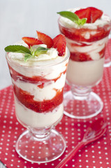 fresh strawberries with whipped cream and mint on the table