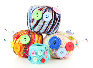Fototapeta na wymiar Colorful buttons and multicolor wool balls, isolated on white