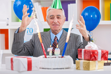 Happiness senior man celebrating 70th birthday