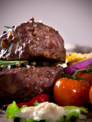 Delicious beef steaks on wooden table