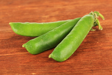 Sweet green peas on wooden background