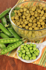 Green peas on wooden background