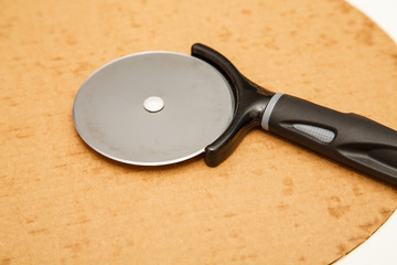 Pizza Cutter on Cardboard Round