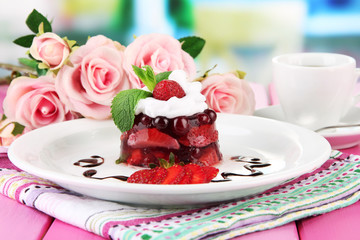Tasty jelly dessert with fresh berries, on bright background