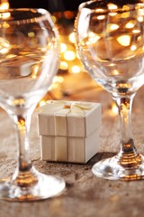 Little gift and wine glass on holiday table