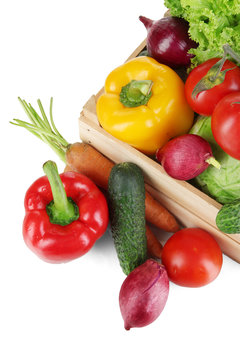 Fresh vegetables in wooden box on grey background