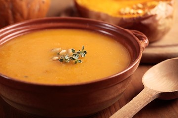 Bowl with pumpkin soup and and baked butternut squash