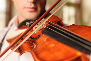 It sounds fascinating. Close up of men playing the violin