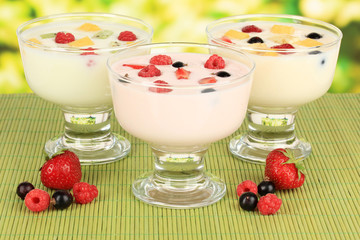 Delicious yogurt with fruit on table on bright background