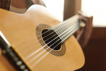 Close-up on the guitar. Close up of men playing acoustic guitar
