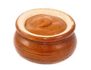 French mustard served in a small ceramic pot