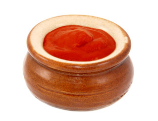 Tomato ketchup served in a small ceramic pot